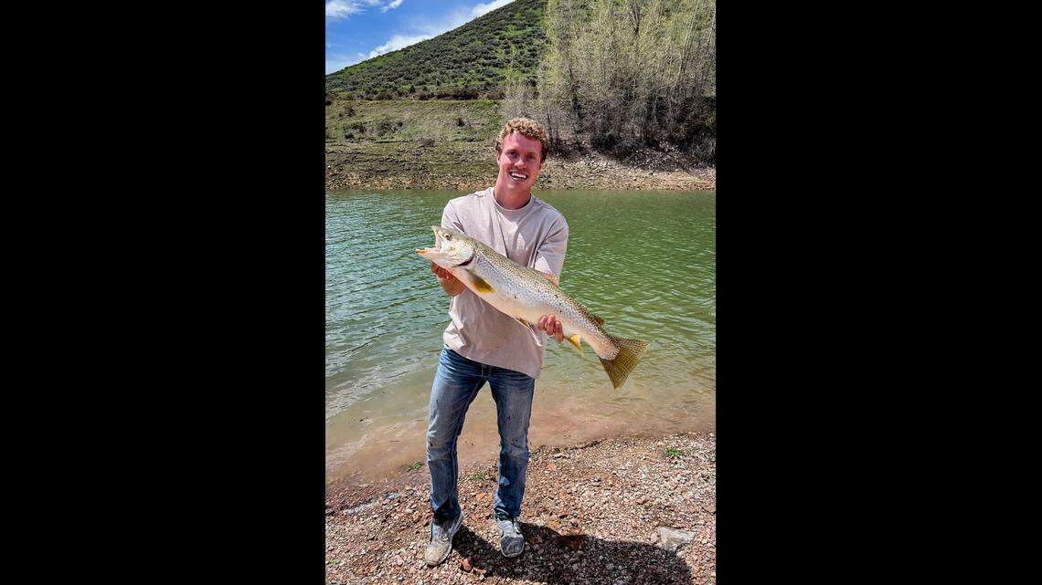 Kody King of Montpelier, Idaho, is shown holding his massive tiger trout. He caught the fish from the Montpelier Reservoir, and it broke the state record for its weight, officials said.