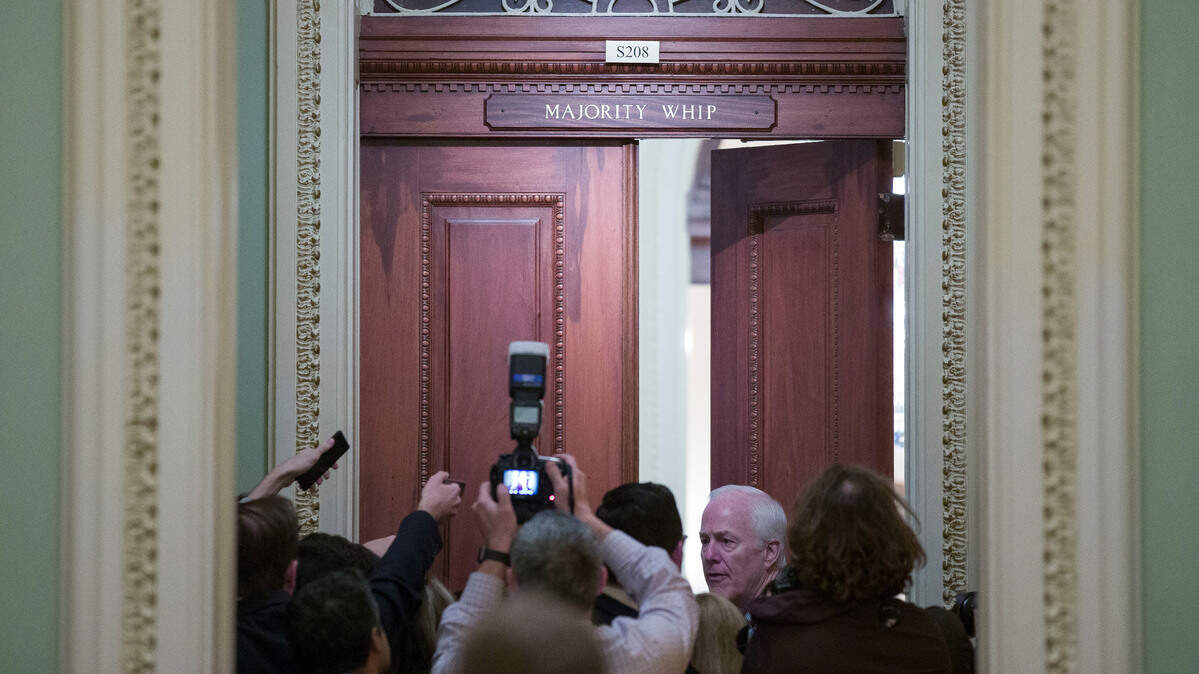 Sen. John Cornyn, R-Texas, talks with reporters before going into his whip office on Capitol Hill, Friday, Dec. 21, 2018.
