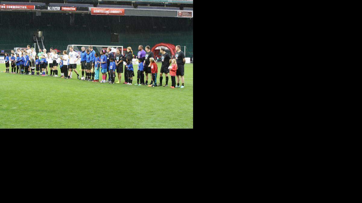 Democrats, Republicans and soccer stars stand side by side with U.S. Soccer Foundation kid participants before the start of the Capital Soccer Classic congressional match, April 14, 2015.

