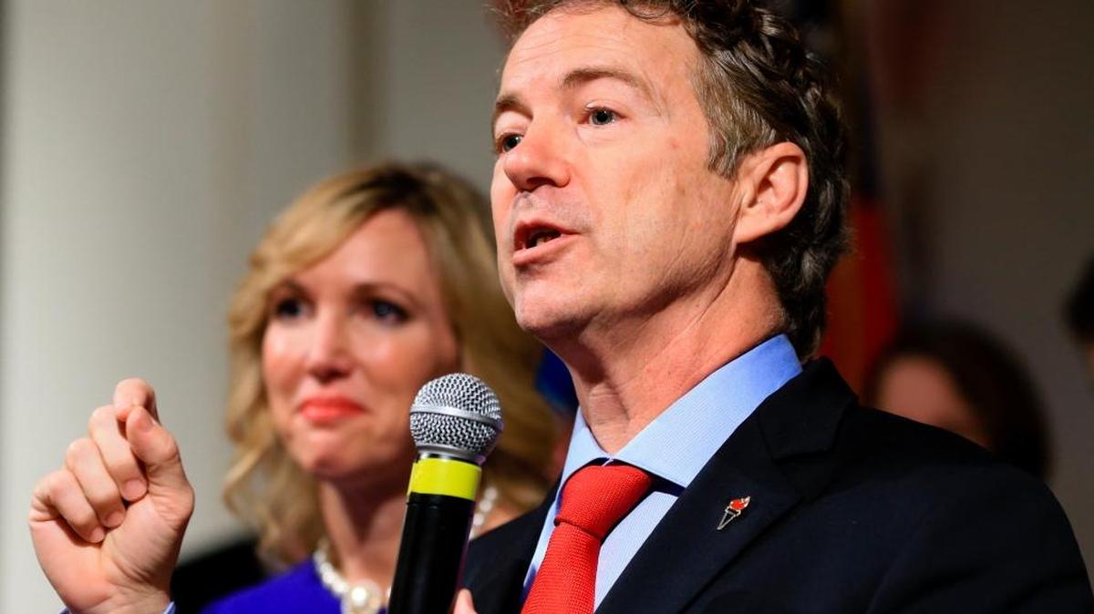 In this Feb. 1, 2016 file photo, Sen. Rand Paul, R-Ky, speaks to supporters with his wife Kelley by his side, during a caucus night victory party at the Scottish Rite Consistory in Des Moines, Iowa. Paul is dropping out of the 2016 race for president.