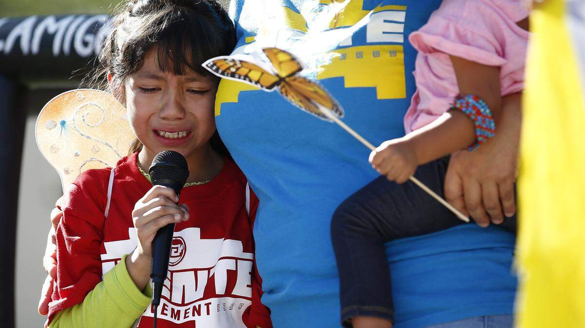 Akemi Vargas, 8, cries as she talks about being separated from her father during an immigration family separation protest, Monday, June 18, 2018, in Phoenix.