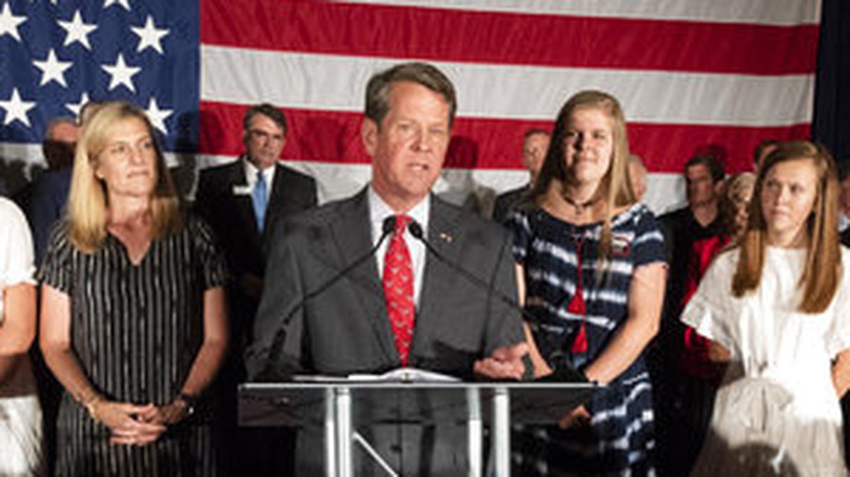 Georgia Secretary of State Brian Kemp, backed by family, speaks during a unity rally, Thursday, July 26, 2018, in Peachtree Corners, Ga. Kemp and fellow Republican Casey Cagle, who was on hand, faced off in a heated gubernatorial primary runoff race which Kemp won. (AP Photo/John Amis)