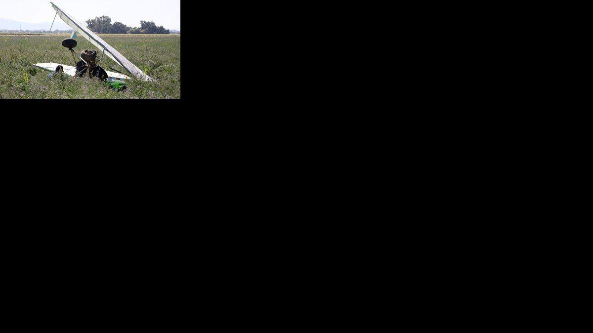 An ultralight aircraft laden with 275 pounds of marijuana lies crumpled in a field in Yuma, Arizona, where it crashed on May 30, 2009. Border Patrol agents said the pilot fled back over the border to Mexico