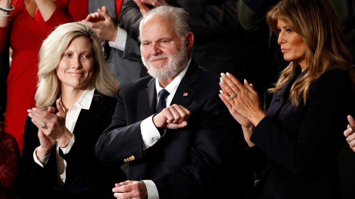 FILE - In this Feb. 4, 2020 file photo, Rush Limbaugh reacts as first Lady Melania Trump, and his wife Kathryn, applaud, as President Donald Trump delivers his State of the Union address to a joint session of Congress on Capitol Hill in Washington. Limbaugh, the talk radio host who became the voice of American conservatism, has died. (AP Photo/Patrick Semansky, File)