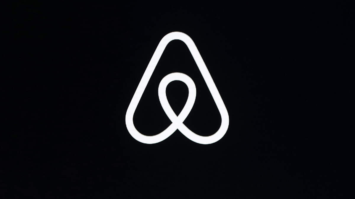 This Feb. 22, 2018, file photo shows an Airbnb logo during an event in San Francisco. The company says it is implementing new policy to prevent landlords from listing rental properties after evicting tenants previously protected by a federal eviction moratorium.
