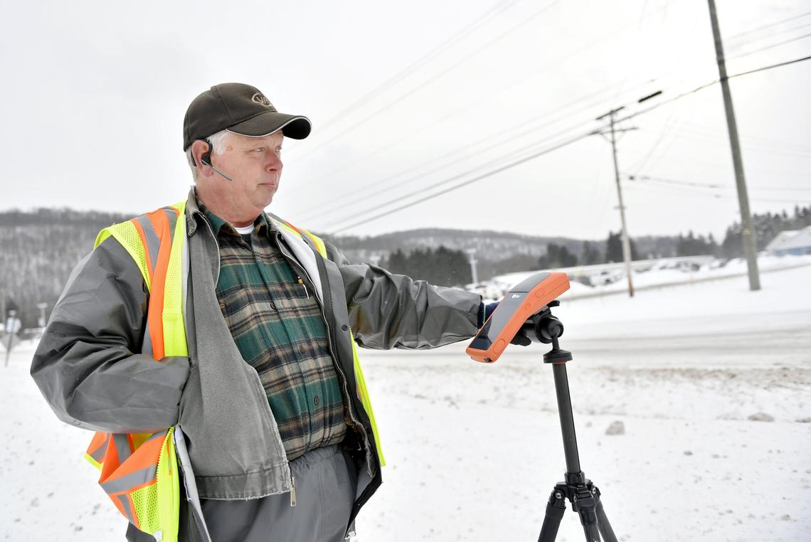 Jim Sheeley with Vantage Point talks shows how he is measuring poles for their database in Potter County on Feb. 13.