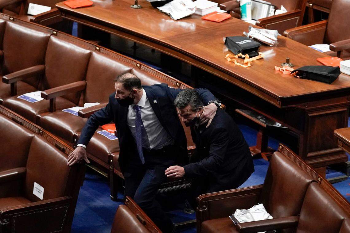 Lawmakers evacuate the floor as rioters try to break into the House Chamber at the U.S. Capitol on Wednesday, Jan. 6, 2021, in Washington. (AP Photo/J. Scott Applewhite)