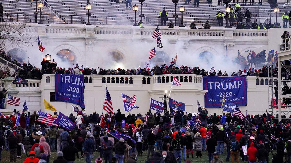 FILE - In this Wednesday, Jan. 6, 2021, file photo, violent protesters storm the Capitol, in Washington. A lawsuit filed Tuesday alleges that former President Donald Trump and others violated the Ku Klux Klan Act in their role in the attack. (AP Photo/John Minchillo, File)