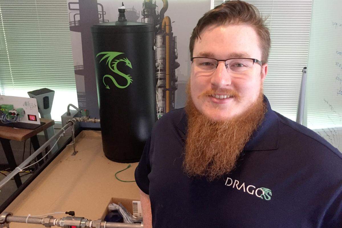 Robert M. Lee, the founder and chief executive of Dragos, an industrial cybersecurity firm, stands before a mockup of an industrial system at his Hanover, Maryland, headquarters.