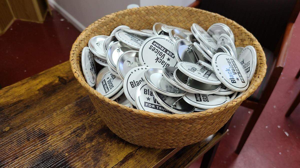 A basket of Black Voices for Trump buttons sit atop the reception desk at a GOP community center in Philadelphia.