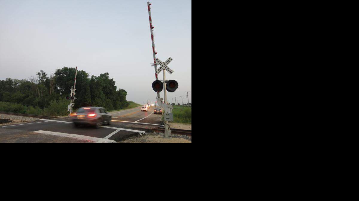 Drivers who get stuck on the track at railroad crossings should immediately call the emergency toll-free number posted at the crossing, such as this one at Cherry Valley, Ill., on Aug. 24, 2014.
