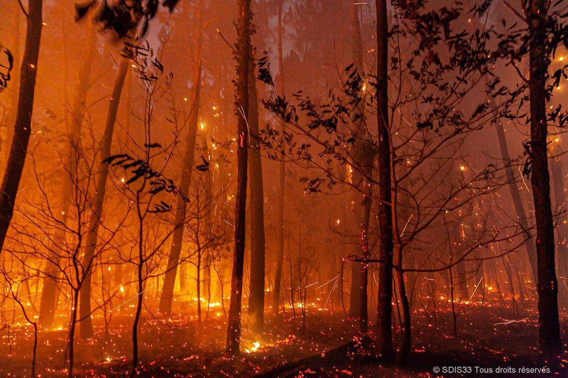 This photo provided by the fire brigade of the Gironde region (SDIS 33) shows a wildfire near Landiras, southwestern France, Sunday July 17, 2022 . Firefighters battled wildfires raging out of control in France and Spain on Sunday as Europe wilted under an unusually extreme heat wave that authorities in Madrid blamed for hundreds of deaths. (SDIS 33 via AP)