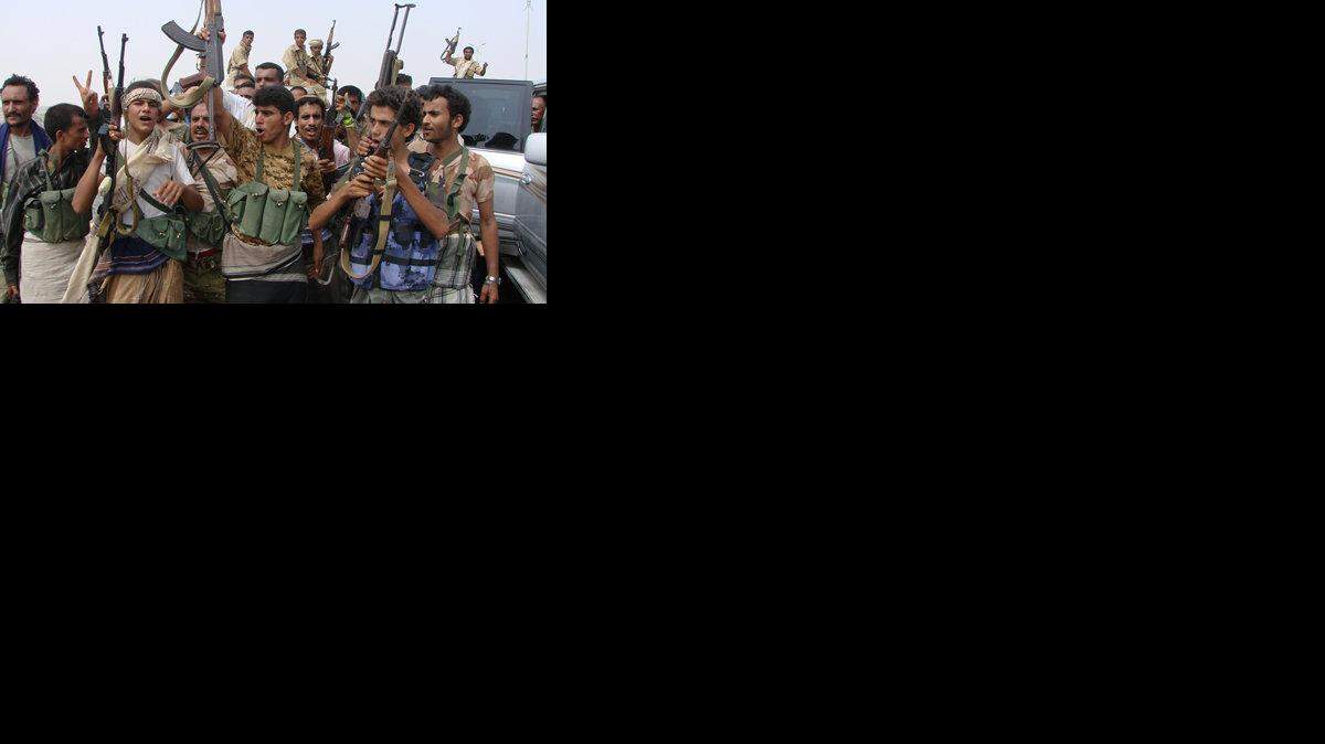 Yemeni army soldiers and tribesmen loyal to the army celebrate after they retook the city of Zinjibar from al-Qaida militants.