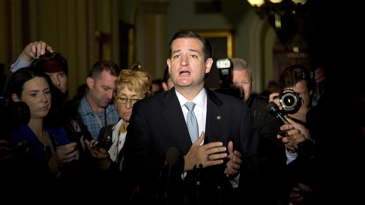 Sen. Ted Cruz, R-Texas, talks to reporters on Capitol Hill after House leaders reached a last-minute agreement to avert a threatened Treasury default and reopen the government after a partial, 16-day shutdown on Oct. 16, 2013.