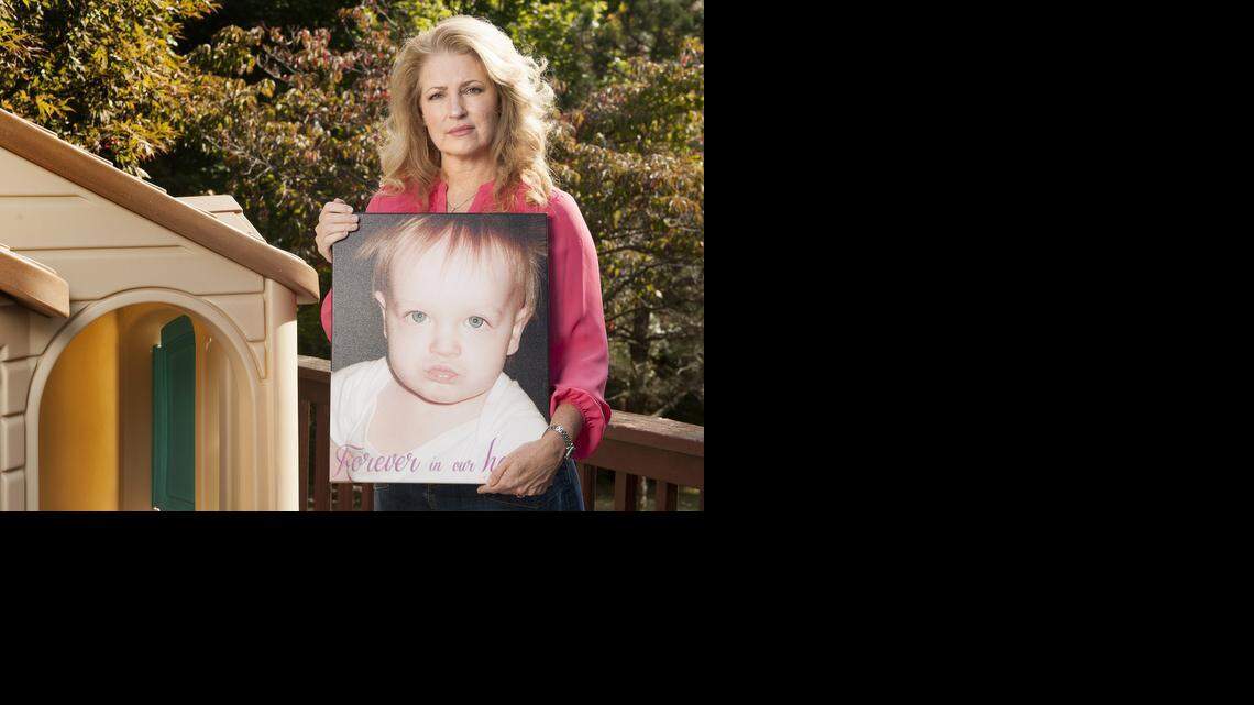Linda Kaiser, president of Parents for Window Blind Safety, poses with a 2002 photograph of her 1-year-old daughter Cheyenne Kaiser on the deck of her home in Barnhart, Missouri Wednesday, Oct. 1, 2014. Cheyenne was killed in 2002 in an accident involving a window blind. (Sid Hastings/McClatchy)
