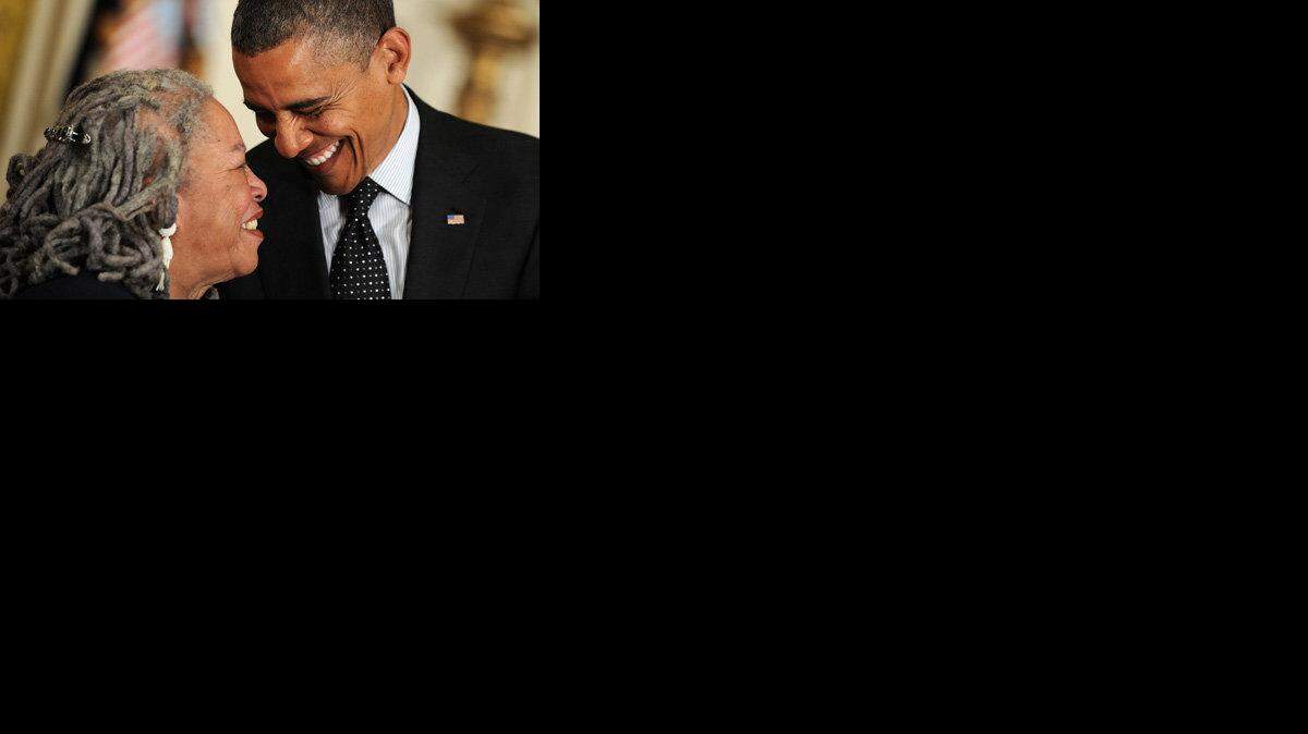 President Barack Obama shares a laugh with author Toni Morrison as he awards her the Presidential Medal of Freedom.
