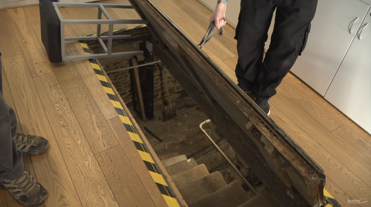 The trapdoor in the shop floor leading to the crypt.