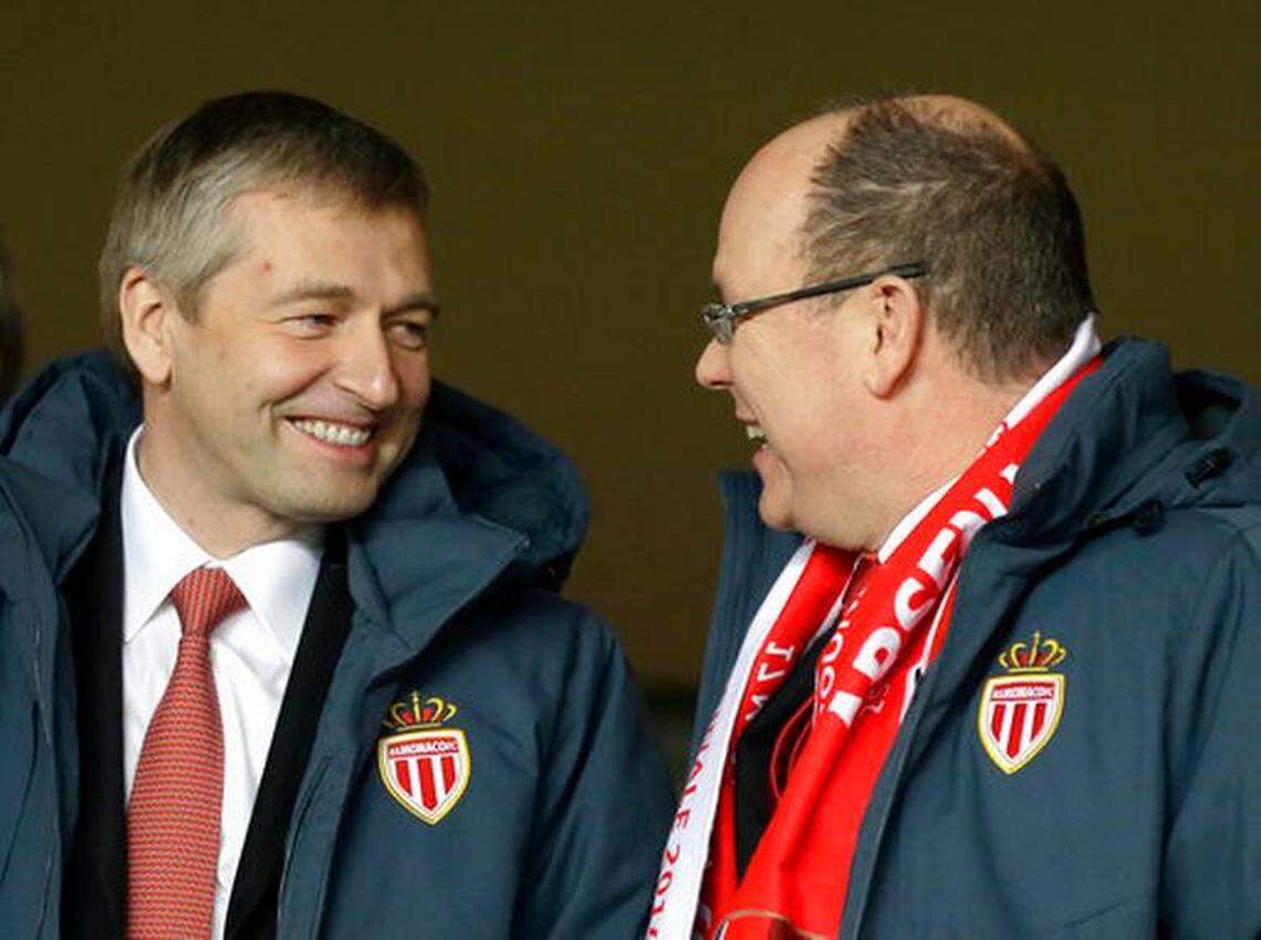 In this Tuesday, March 17, 2015, file photo, Prince Albert II of Monaco, right, and the president of AS Monaco, Dmitry Rybolovlev, speak in the stands before the Champions League round of 16 second leg soccer match between Monaco and Arsenal at Louis II stadium in Monaco. A lawyer involved in the case says the Russian tycoon has been detained in the principality in an investigation into suspected corruption and other allegations.