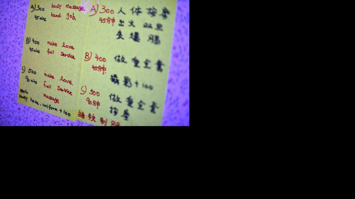 Prices are posted in Hong Kong Dollars inside the work apartment of sex worker "Miss F," in Sham Shui Po, on the edge of Mong Kok in Hong Kong, China on Oct. 8, 2014. (Chris Stowers/McClatchy)

