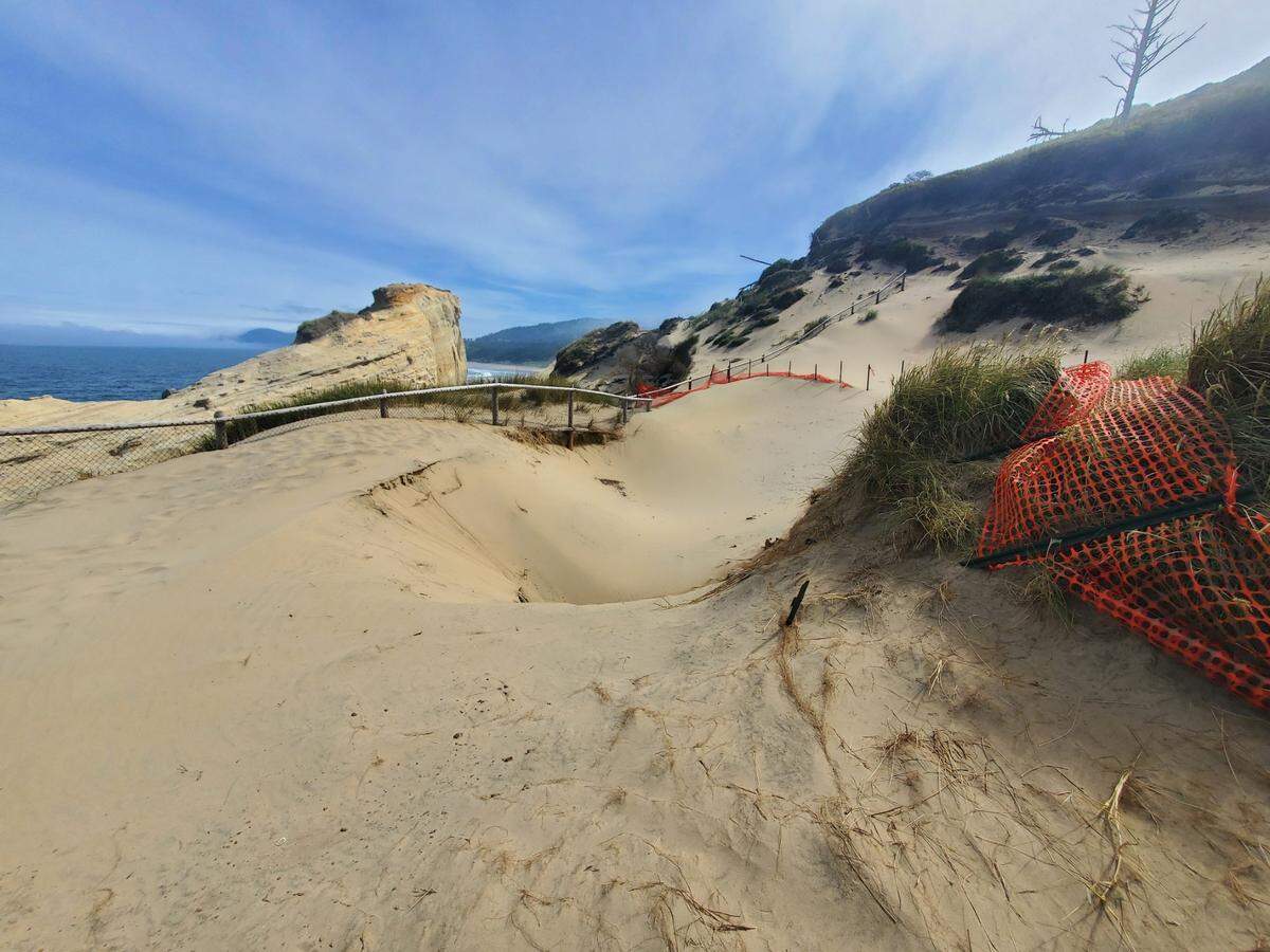 Two sinkholes have merged along the coastline at Cape Kiwanda State Natural Area near Pacific City, Oregon, officials said. Strong winds have caused sand to cover the opening of the sinkhole.