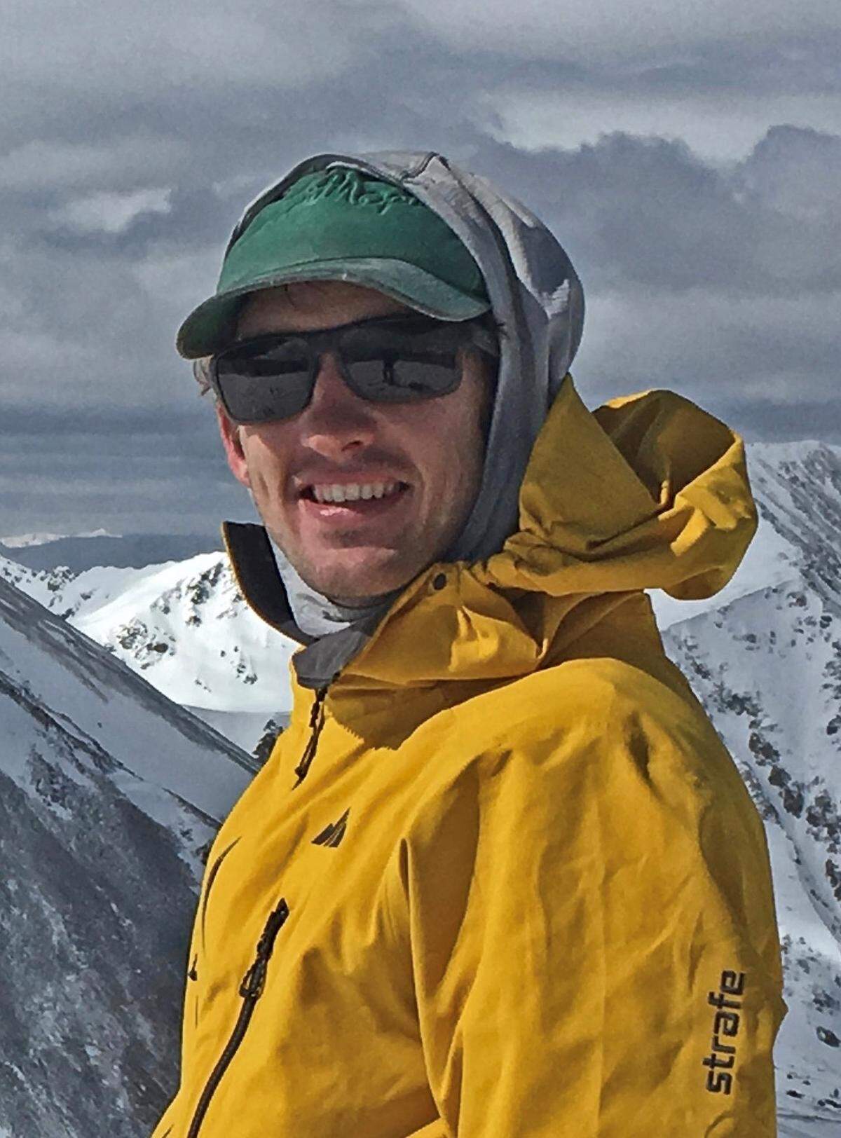 Josh Jespersen smiles upon reaching the summit of Kelso Mountain in Colorado