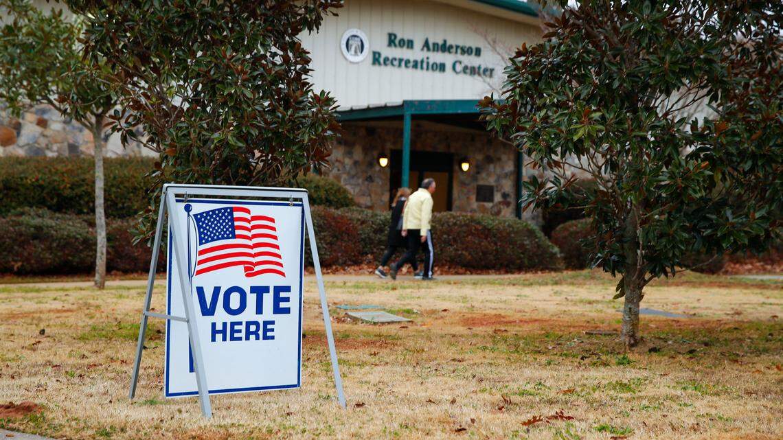 Voters return to their vehicles after early voting for the Senate runoff election, at Ron Anderson Recreation Center, Thursday, Dec. 17, 2020, in Powder Springs, Ga. (AP Photo/Todd Kirkland)