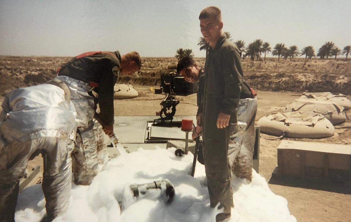 Former Marine Corps Sgt. Mark S. Villamac Ho (right, back row) deployed to Iraq in 2003 as an aviation rescue firefighter. In this picture, he and the Marines he served with are exposed to firefighting foam in Al Numaniyah, Iraq. The Defense Department is phasing out the foam due to its links to cancer. In 2017 Ho was diagnosed with myeloma, a blood cancer and doctors found a second cancer in his nasal passages.