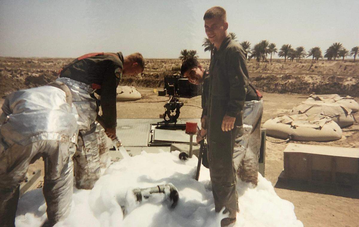 Former Marine Corps Sgt. Mark S. Villamac Ho (right, back row) deployed to Iraq in 2003 as an aviation rescue firefighter. In this picture, he and the Marines he served with are exposed to firefighting foam in Al Numaniyah, Iraq. The Defense Department is phasing out the foam due to its links to cancer. In 2017 Ho was diagnosed with myeloma, a blood cancer and doctors found a second cancer in his nasal passages.