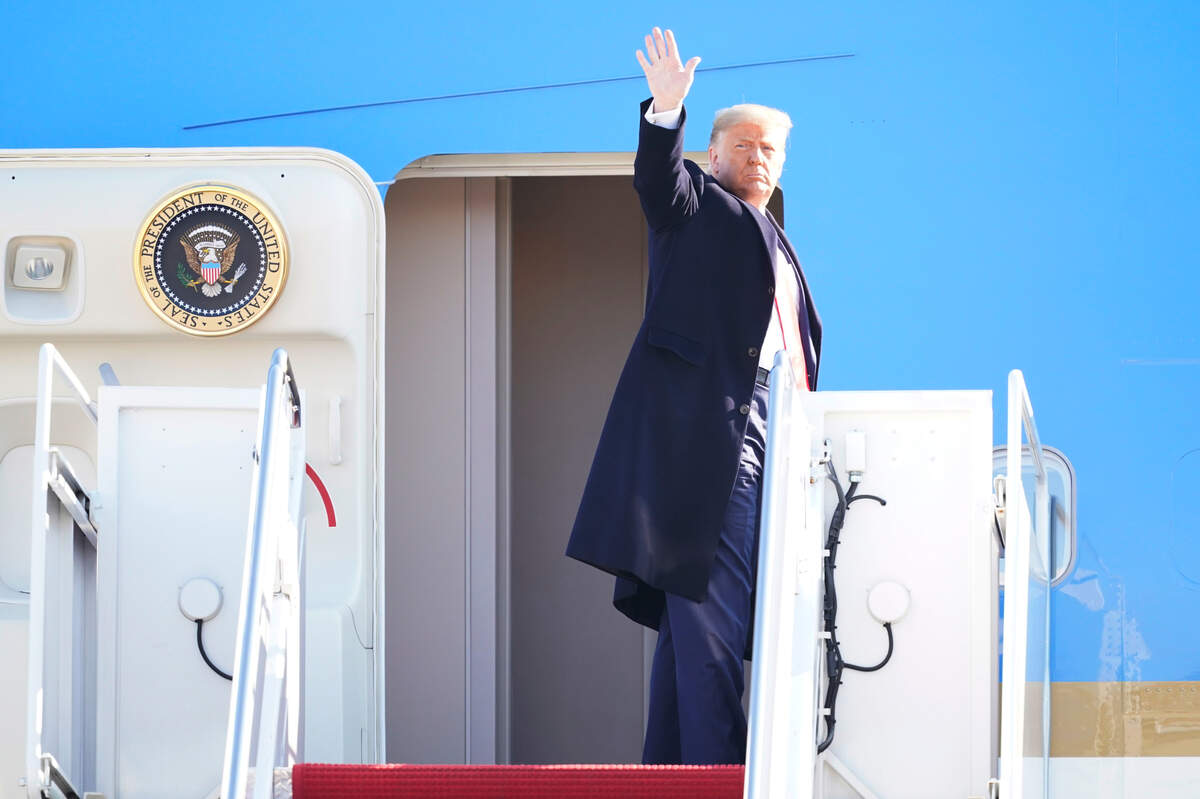 President Donald Trump waves before boarding Air Force One at Andrews Air Force Base, Md., for a trip to Alamo, Texas, Tuesday, Jan. 12, 2021. (AP Photo/Manuel Balce Ceneta)