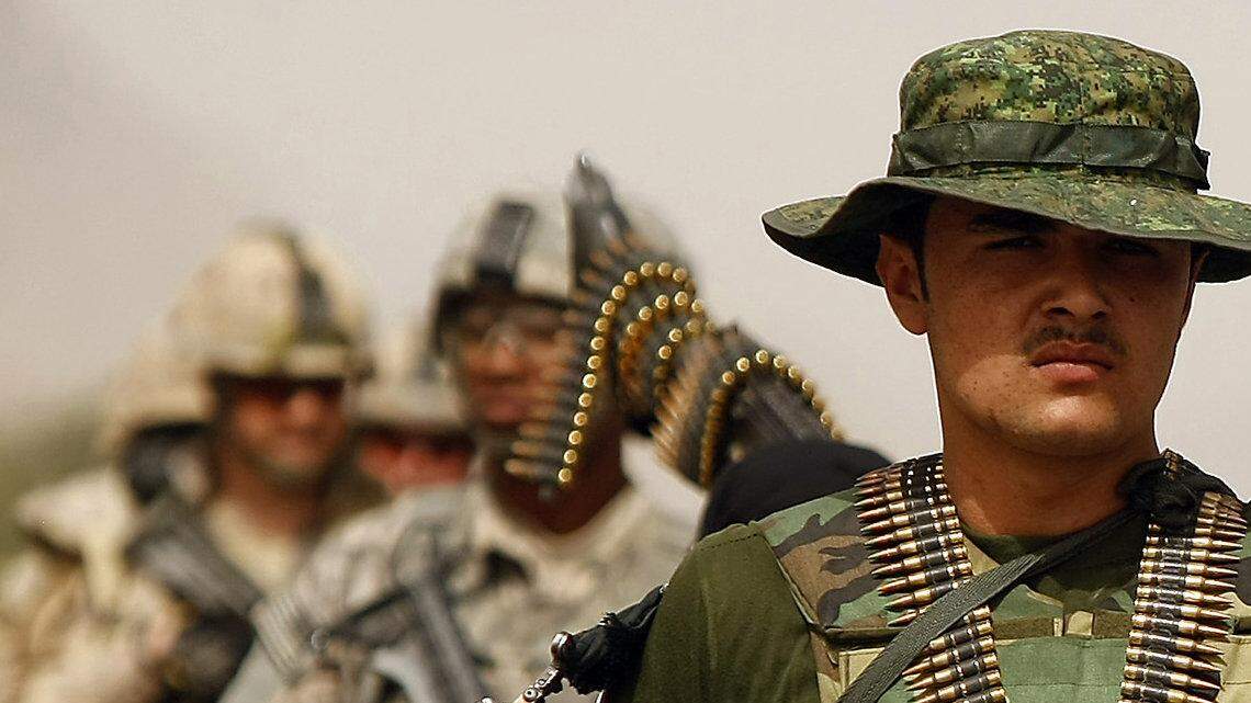 U.S. and Afghan forces patrol a Kandahar neighborhood.