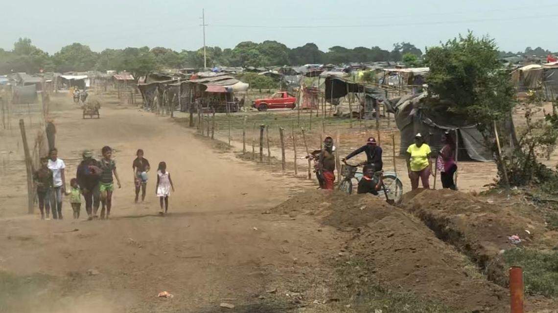 Squatters walk along a newly built road in a settlement on the outskirts of Chinandega, Nicaragua, on July 24, 2018. The settlement was established in early June on farmland that was seized without compensation, with the support of authorities in the ruling Sandinista Front.