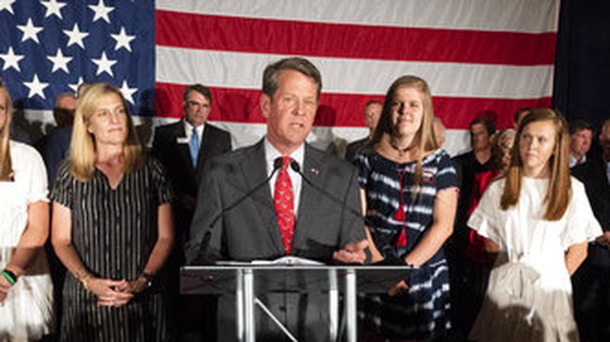 Georgia Secretary of State Brian Kemp, backed by family, speaks during a unity rally, Thursday, July 26, 2018, in Peachtree Corners, Ga. Kemp and fellow Republican Casey Cagle, who was on hand, faced off in a heated gubernatorial primary runoff race which Kemp won. (AP Photo/John Amis)