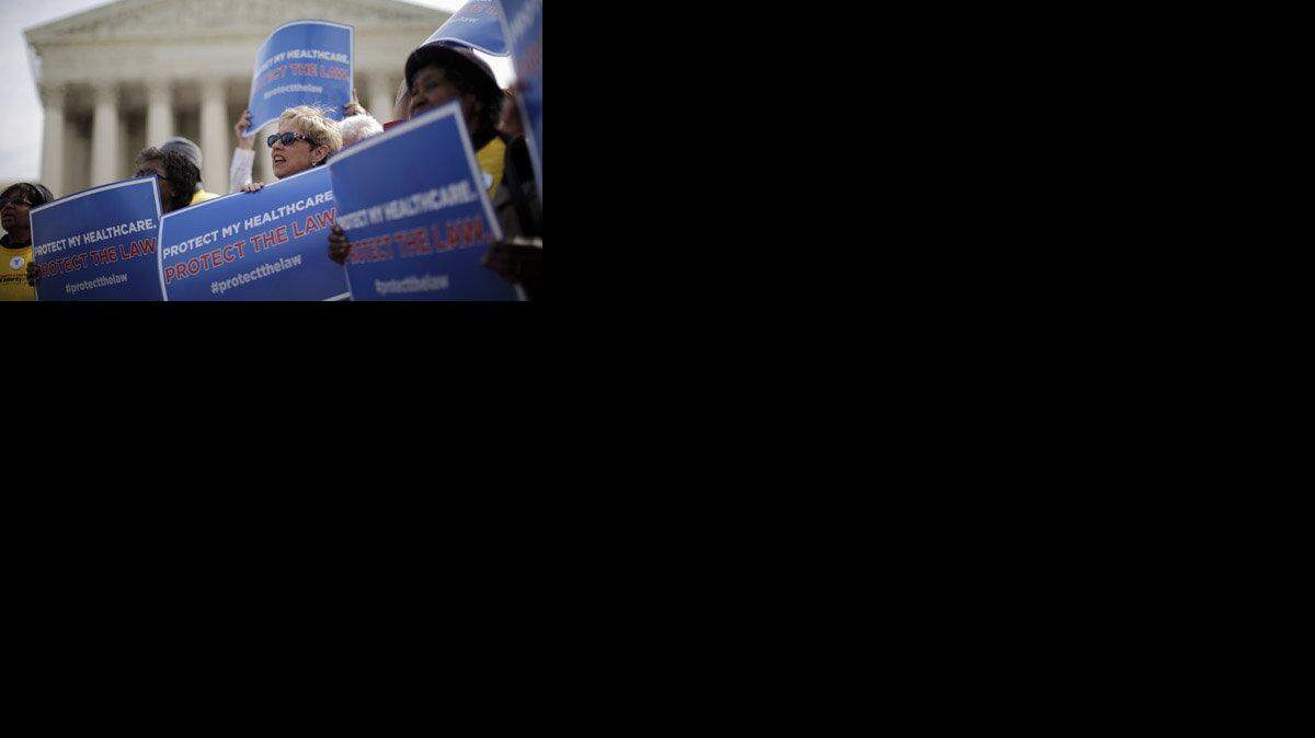 Supporters of health care reform rally in front of the Supreme Court in Washington D.C.