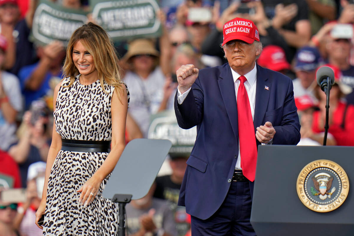 President Donald Trump pumps his fist as first lady Melania Trump smiles at supporters after a campaign rally Thursday, Oct. 29, 2020, in Tampa, Fla. (AP Photo/Chris O’Meara)