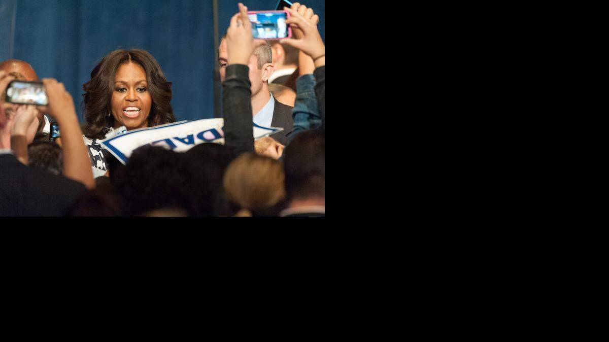 First Lady Michelle Obama greets a crowd of Mark Udall supporters at a Udall Senate reelection campaign visit in Denver Oct. 23, 2014. Obama visited Denver in hopes of turning a difficult senate race in Udall's favor.

