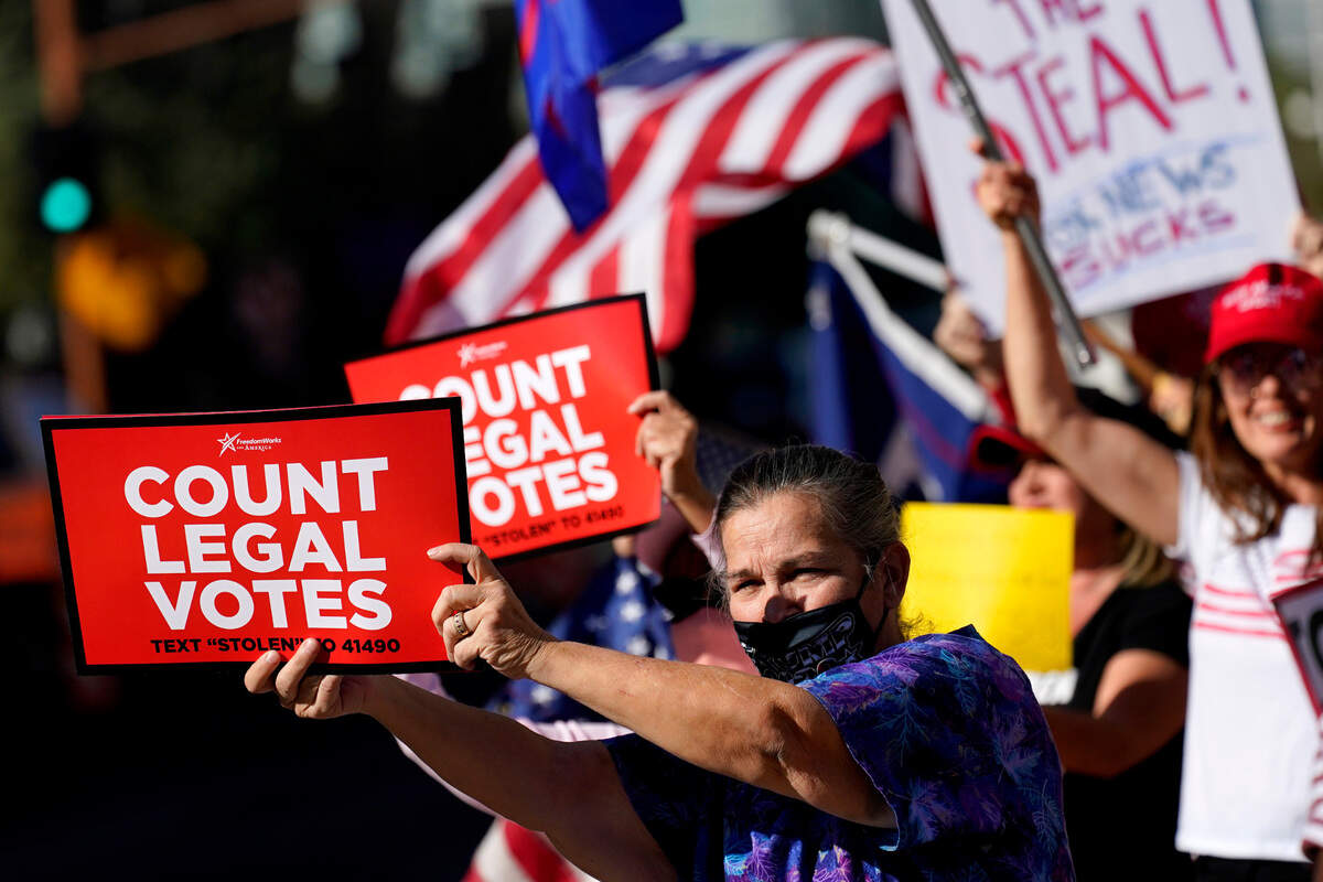 People rally outside City Hall, Thursday, Nov. 5, 2020, in Phoenix. Dozens of pro-Trump protesters gathered to protest after Democratic challenger Joe Biden was reported to have flipped the Republican stronghold of Arizona. (AP Photo/Matt York)