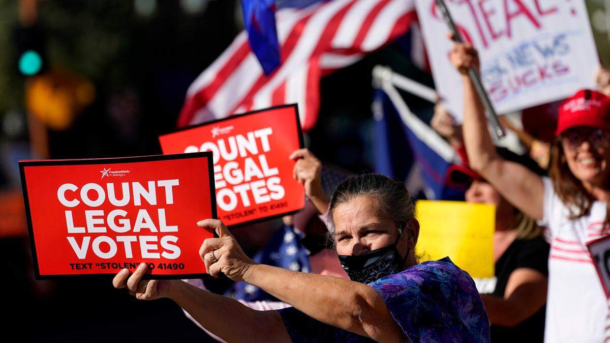 People rallied outside City Hall in Phoenix on Nov. 5, 2020. Dozens of pro-Trump protesters gathered to protest after Democratic challenger Joe Biden was reported to have flipped the Republican stronghold of Arizona. 