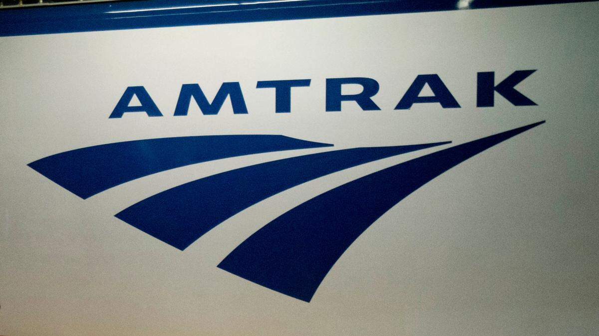 FILE - In this Feb. 6, 2014 file photo, an Amtrak logo is seen on a train at 30th Street Station in Philadelphia. Amtrak is modifying service in the Northeast and Midwest because of winter storms moving through the region. The Capitol Limited, from Chicago to Washington, and the Lake Shoe Limited, from Chicago to New York, are canceled on Saturday, Jan. 19, 2019. (AP Photo/Matt Rourke, File)
