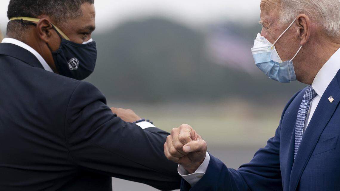 President-elect Joe Biden greets Rep. Cedric Richmond, D-La., left, as he arrives at Columbus Airport in Columbus, Ga., Tuesday, Oct. 27, 2020, to travel to Warm Springs, Ga. for a rally. (AP Photo/Andrew Harnik)