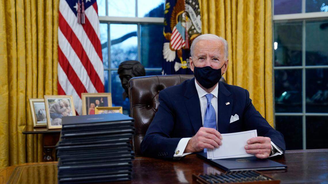 President Joe Biden pauses as he signs his first executive orders in the Oval Office of the White House on Wednesday, Jan. 20, 2021, in Washington. The president plans to sign additional orders and directives related to the pandemic on Thursday. (AP Photo/Evan Vucci)