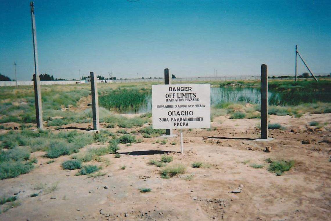 Service members deployed to Karshi-Khanabad, Uzbekistan, or “K2” called these ponds outside the base the “Skittles,” so-named after the candy because they glowed bright green, and often had other colors in them too. The ponds were right behind a sign that warned “Radiation Hazard.” The base was a critical part of the war on terrorism in the months and years right after 9/11, but now the men and women who deployed are facing cancer diagnoses.