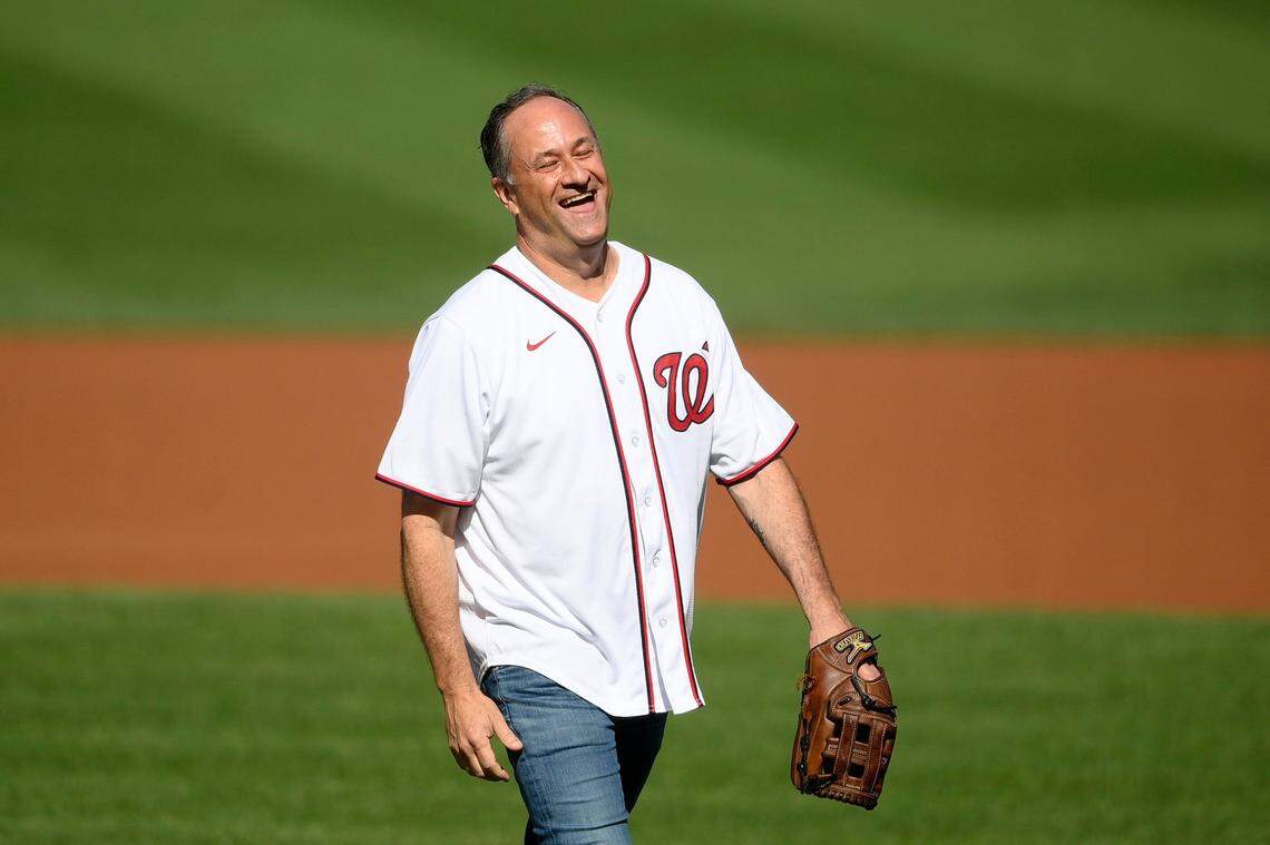 Doug Emhoff, second gentleman of the United States, reacts after he threw out the ceremonial first pitch before a baseball game between the Washington Nationals and the Colorado Rockies, on Sept. 18, 2021, in Washington.