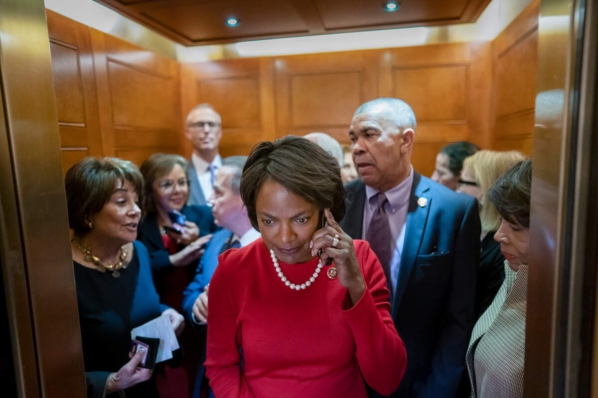 Rep. Val Demings, D-Fla., center, and other House Democrats crowd into an elevator as they rush to the chamber for a vote just after meeting with Speaker of the House Nancy Pelosi, D-Calif., who is moving swiftly toward House passage of a coronavirus aid package possibly this week, on Capitol Hill in Washington, Wednesday, March 11, 2020. (AP Photo/J. Scott Applewhite)