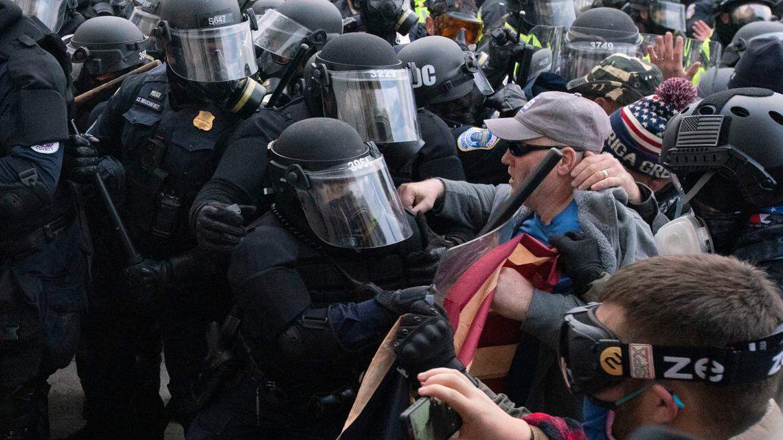 Capitol police officers in riot gear push back demonstrators who try to break a door of the U.S. Capitol on Wednesday, Jan. 6, 2021, in Washington. (AP Photo/Jose Luis Magana)