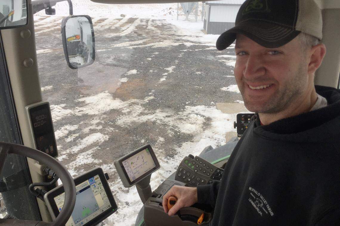 Jerrel Brubaker of Buffalo Valley Farmstead sits in the cab of his modern tractor with self-steering functionality. Brubaker says he could spray paint the windows black on his tractor and it could still plant rows of crops perfectly using auto-steer.