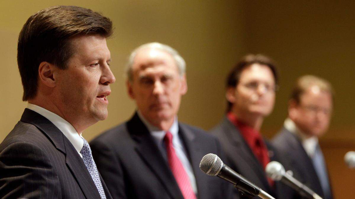 John Hostettler, left, answers a question as U.S. Senate candidates running in the GOP primary participate in a debate at Franklin College in Franklin, Indiana, April 19, 2010.