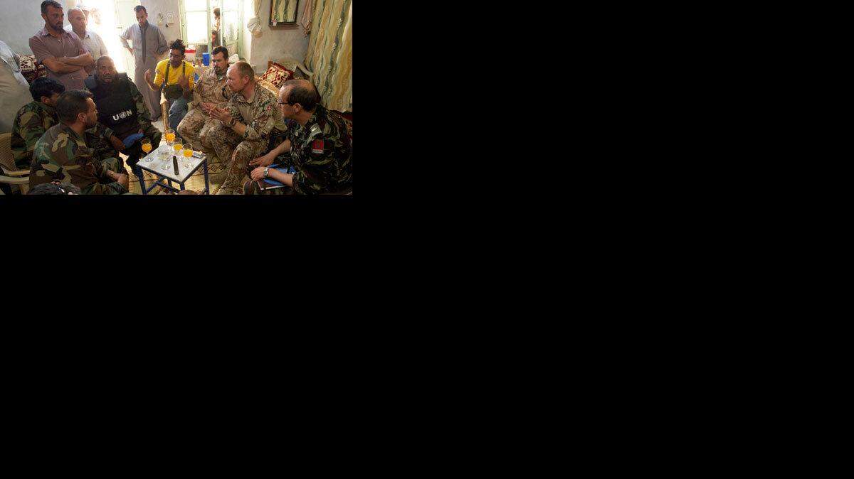 The United Nations observer team based in Hama meets with Free Syrian Army leaders, May 31, 2012 in Latamneh, Syria. The commander, Danish LtCol. Peter Dahl, expressed frustration with the lack of progress in peace negotiations and exchanged contact information with the FSA commander. (Austin Tice/MCT)