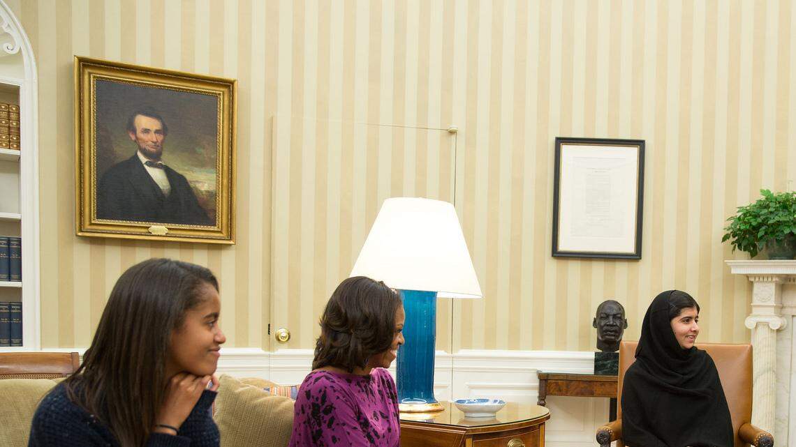 President Barack Obama, First Lady Michelle Obama, and their daughter Malia meet with Malala Yousafzai, the young Pakistani schoolgirl who was shot in the head by the Taliban a year ago, in the Oval Office, Oct. 11, 2013.
