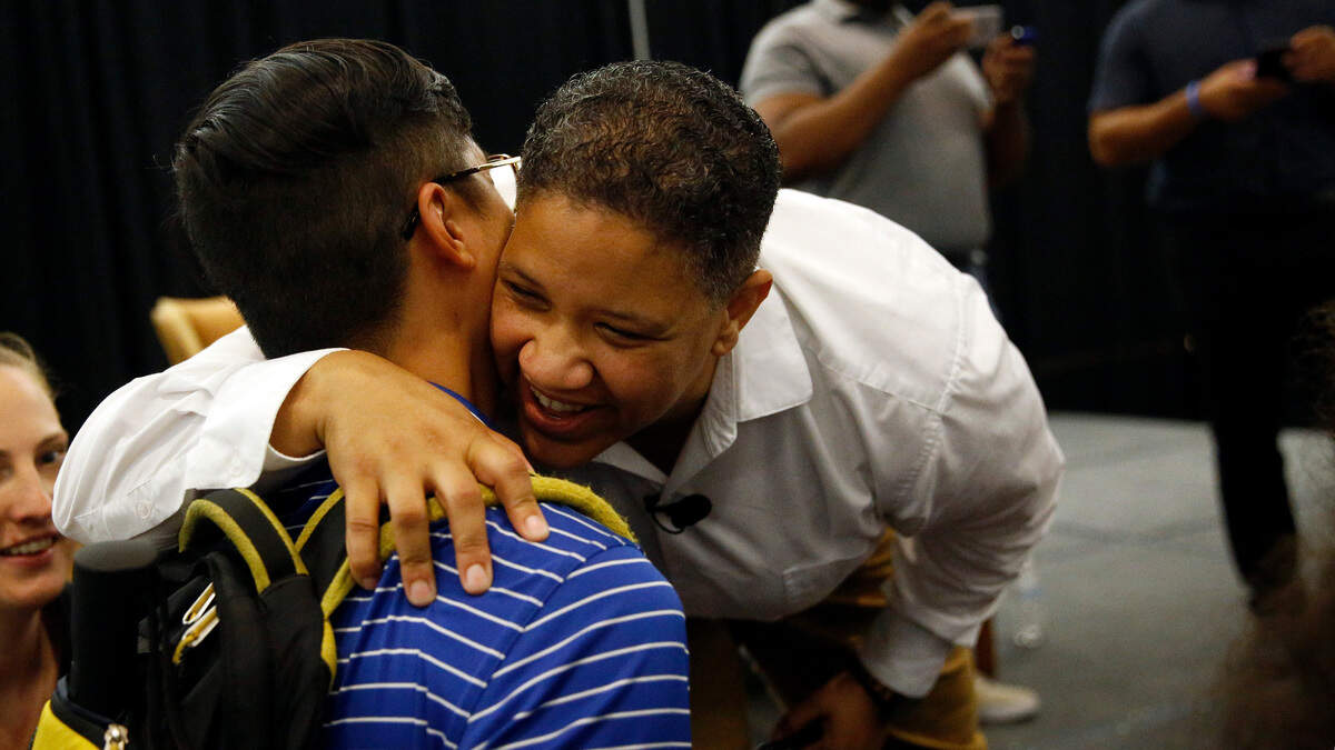 Delaware Democrat Kerri Evelyn Harris hugs a supporter after participating in a town hall, Friday, Aug. 31, 2018, at the University of Delaware in Newark, Del.