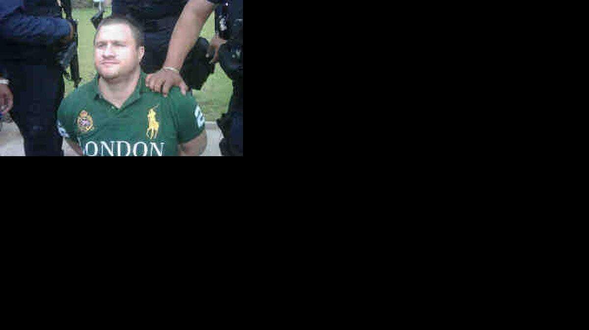 'La Barbie,' whose followers are infamous for beheading their victims, under arrest on Monday.